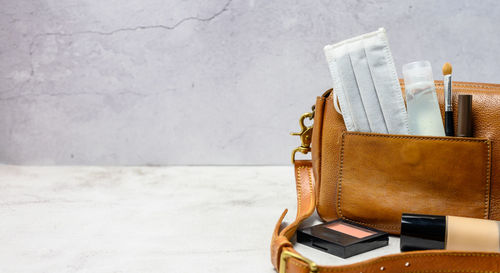 Close-up of open book on table against wall