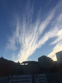 Low angle view of buildings in town against sky