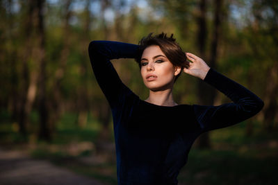 Beautiful young woman standing in a garden