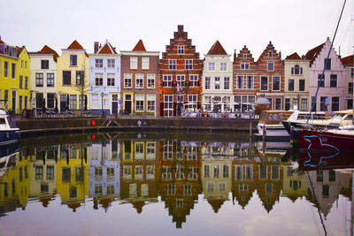 Reflection of buildings on canal in city