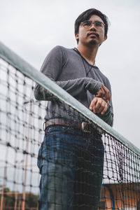 Low angle view of man standing against sky