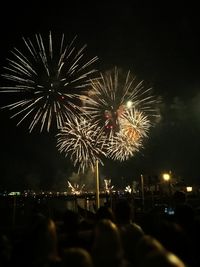 Low angle view of firework display at night