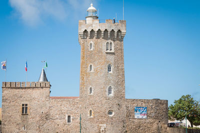 Low angle view of historic building against blue sky