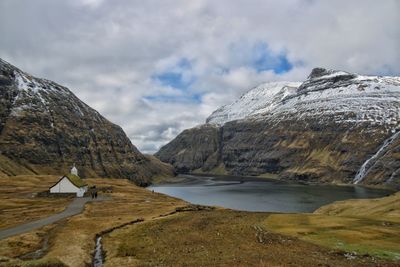 Scenic view of snowcapped mountains against cloudy sky