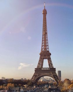 Low angle view of eiffel tower in city against blue sky