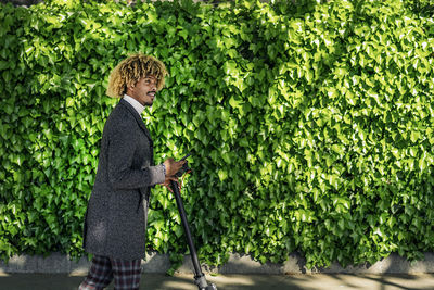 Side view of man standing against plants