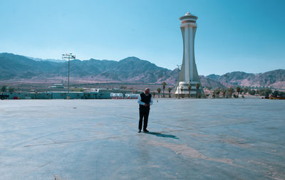 Rear view of man standing on mountain