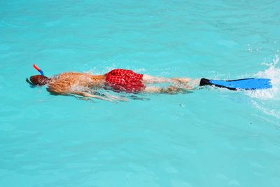 High angle view of man snorkelling in turquoise water