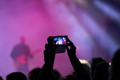 Man photographing at music concert