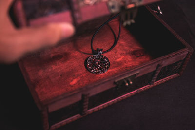 High angle view of clock hanging on wood