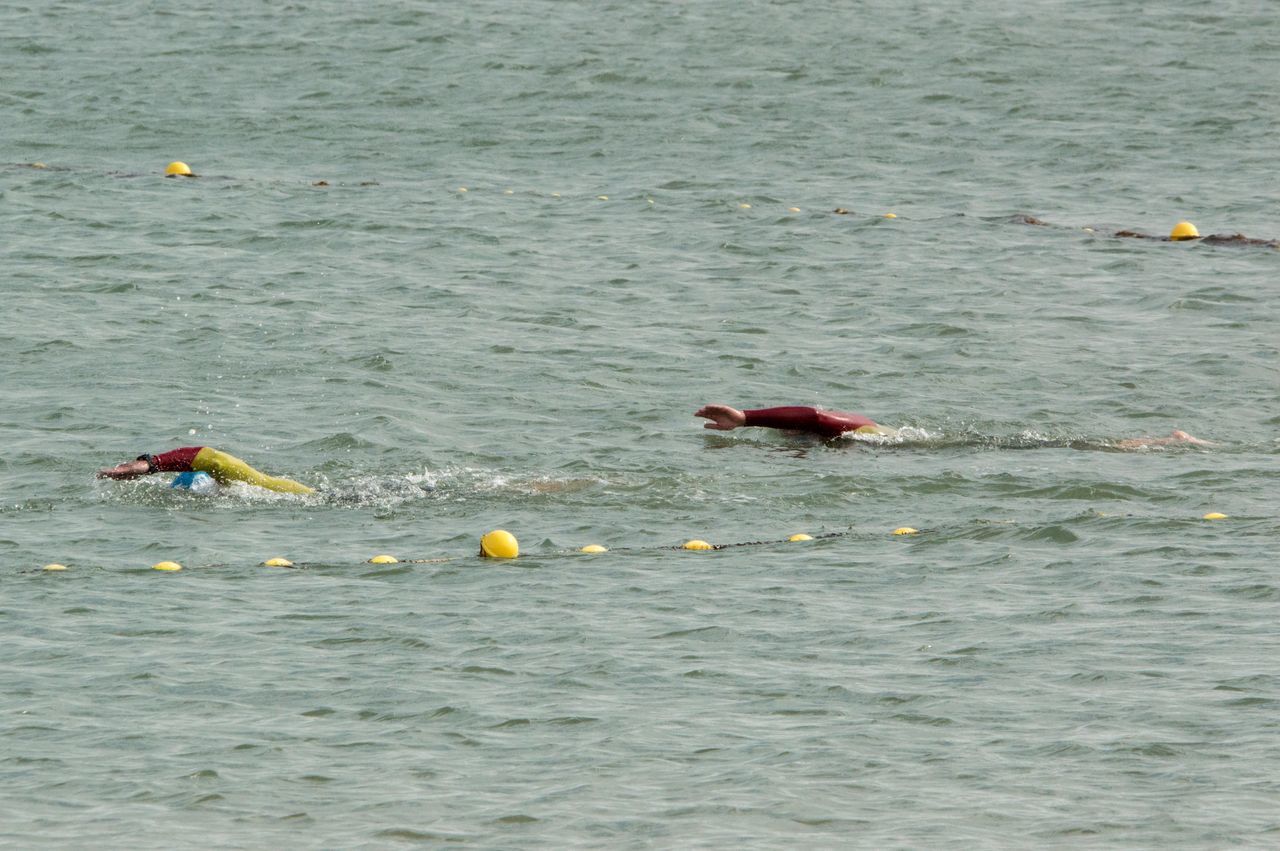 PEOPLE SWIMMING IN SEA