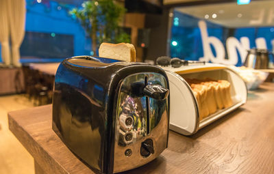 Close-up of illuminated lamp on table