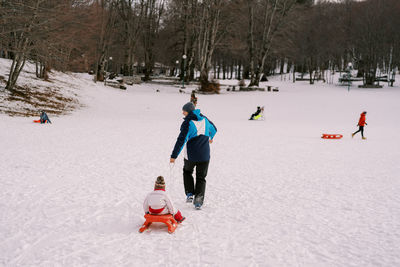 High angle view of man skiing on snow covered field