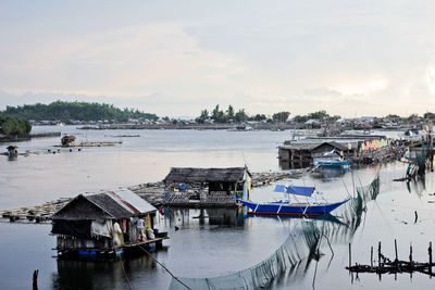 Boats moored on sea against sky