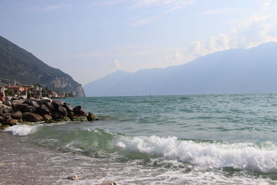 Scenic view of sea and mountains against sky