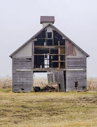 Broken down corn crib near a corn field