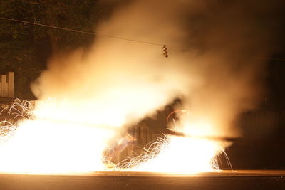 Blurred motion of woman with fire crackers at night