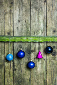Close-up of christmas decorations hanging on wood