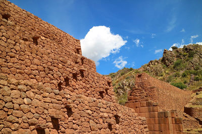 Low angle view of castle against cloudy sky