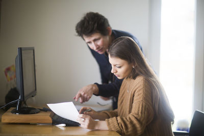 Women discussing a paper in an office