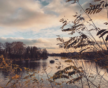 Scenic view of lake against sky at sunset