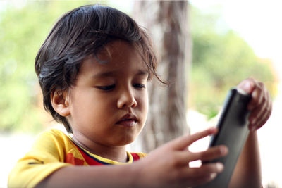 Close-up of man using mobile phone