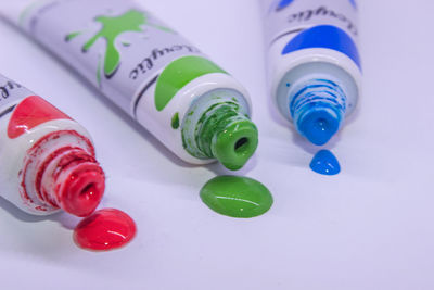 High angle view of multi colored bottles on table