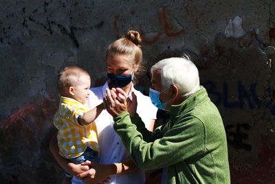 People with mask standing outdoors
