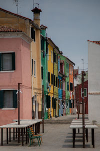 Houses by street in town against sky