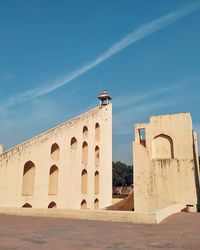 Low angle view of a building at jantar mantar jaipur against blue sky