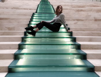 Woman sitting on staircase