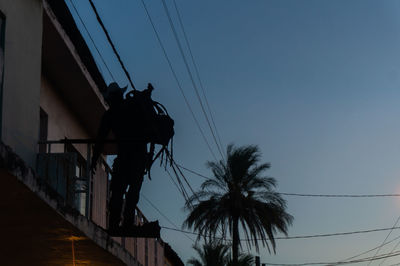 Low angle view of silhouette building against sky