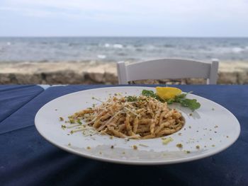 Close-up of food served on table at beach