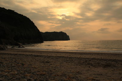 Scenic view of beach against sky during sunset