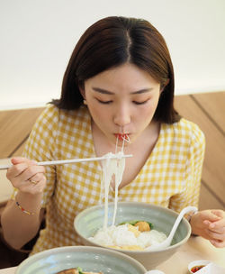 Midsection of woman holding ice cream in bowl