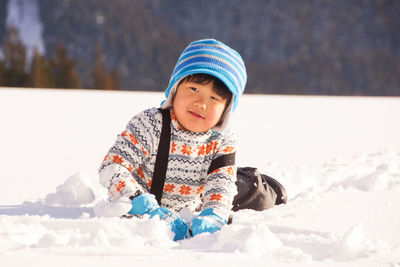 Portrait of smiling boy in snow