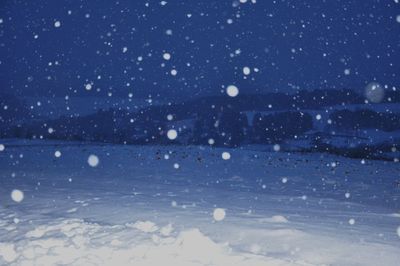 Snow covered land against sky