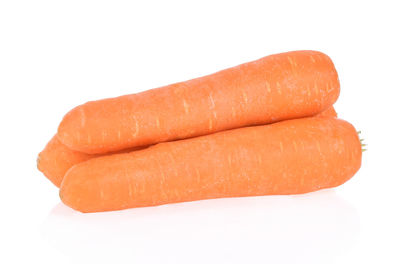 Close-up of carrots over white background