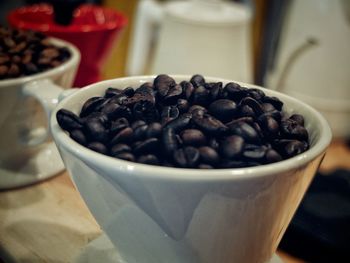Close-up of coffee beans in bowl on table