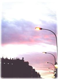 Low angle view of illuminated street light against sky