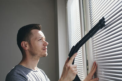 Portrait of young man looking at home