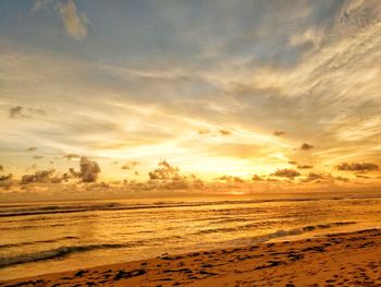 Scenic view of beach against sky during sunset