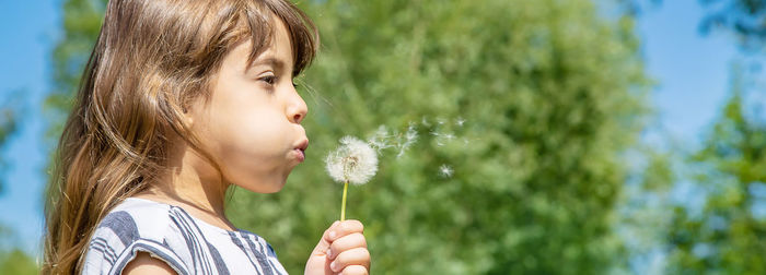 Close-up of young woman blowing bubbles