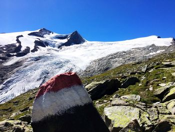 Low angle view of painted rock by european alps against clear sky