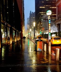 Illuminated street lights in city at night