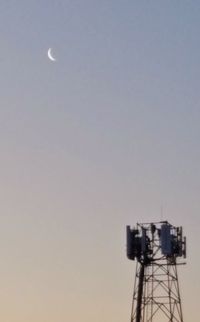 Low angle view of communications tower against sky