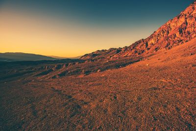 Scenic view of mountains against clear sky during sunset