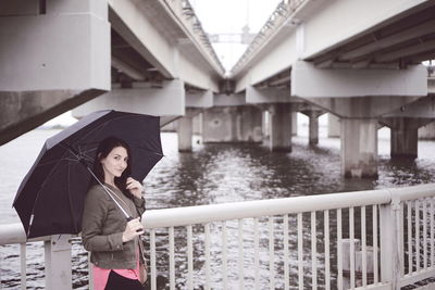 Woman standing on bridge