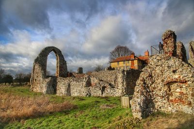 Old ruin on field against sky