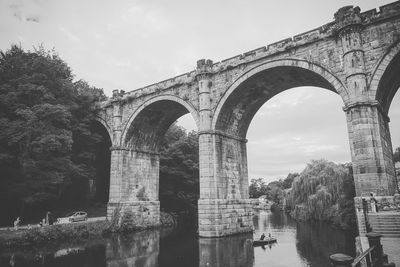 Low angle view of arch bridge against sky